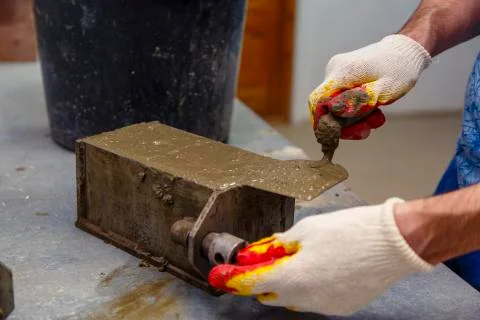 A member of the construction of the laboratory takes a sample of concrete. He Stock Photos
