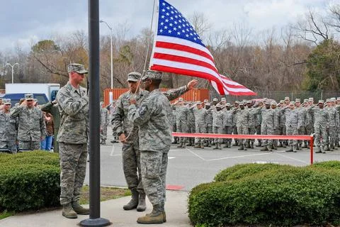 Members of the 202nd Engineering Installation Squadron (EIS) hoist a flag ... Stock Photos