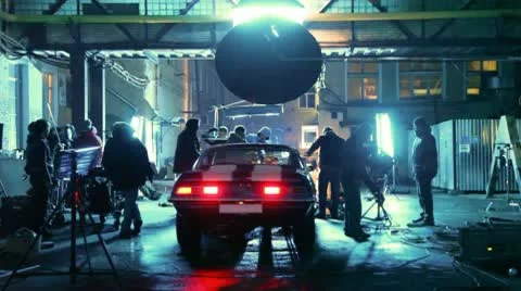 Members of film crew are engaged in installation of equipment round car Stock Footage 10681794