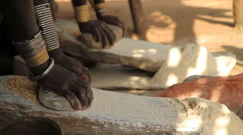 Members of an Omo Valley Tribe Using Traditional Methods to Grind Flour Stock Footage 66519429