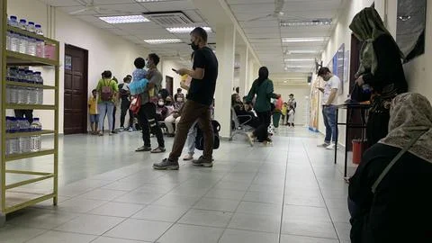 Members of the public are waiting for a queue number to see a doctor Stock Photos