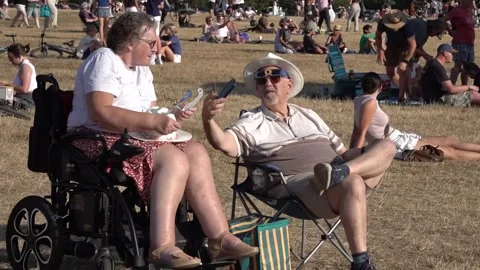 Members of the public in Bristol share how they are watching the eclipse Stock Footage 342074161