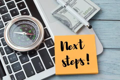 Memo note written with NEXT STEPS!. Top view Stock Photos