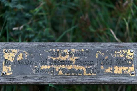 Memorial bench "sit a while" in memory of Seamus Behan along Howth Cliff Walk Stock Photos