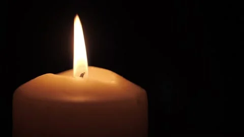 Memorial candle burns on a dark background Stock Footage 206472106
