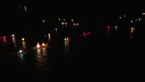 Memorial candles illuminating cobblestone on all saints' day Stock Footage 324531853