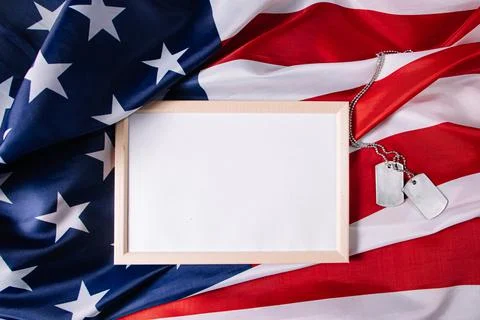 Memorial Day concept. Empty frame for text and American flag. Military dog ta Stock Photos
