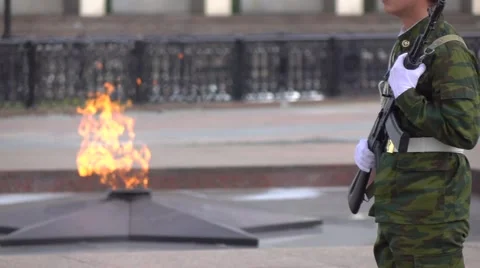 Memorial fire and armed soldier. Super slow motion long shot Stock Footage
