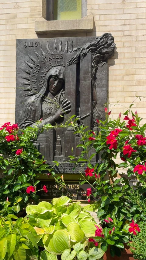 A memorial statue of the Virgin Mary embracing the World Trade Center towers Stock Footage 345153601