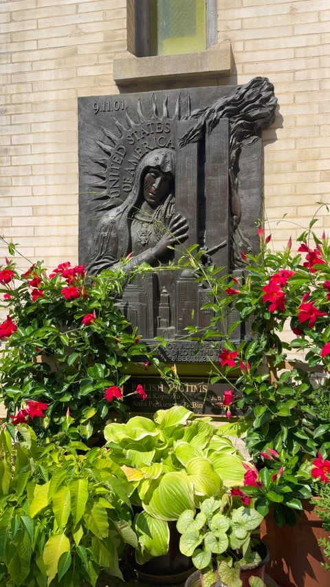 A memorial statue of the Virgin Mary embracing the World Trade Center towers Stock Footage 345154272