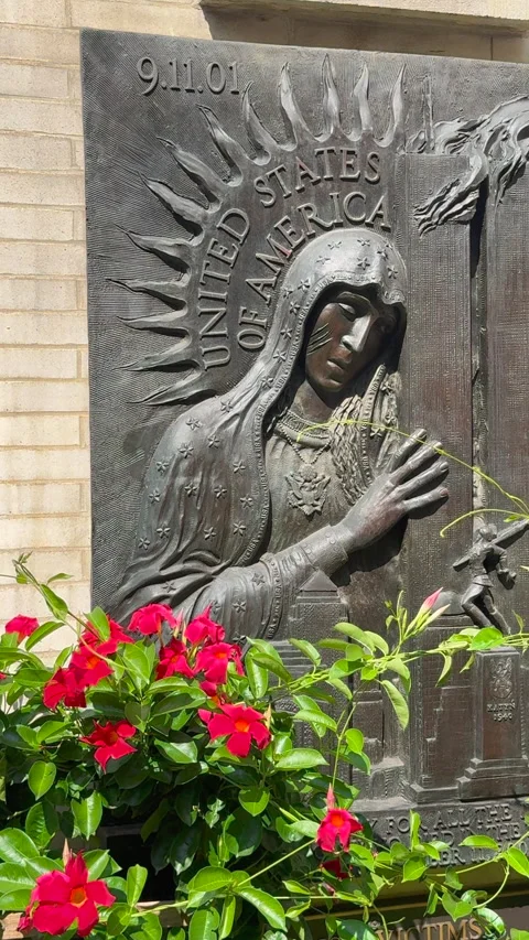 A memorial statue of the Virgin Mary embracing the World Trade Center towers Stock Footage 345156472