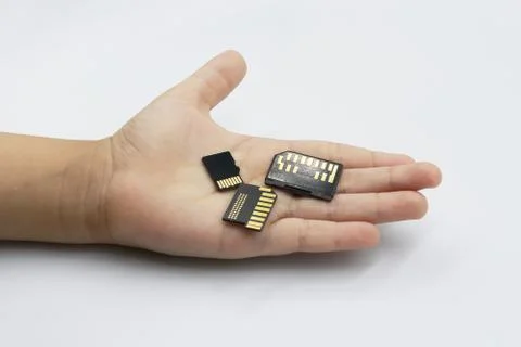 Memory card in kids hand isolated on white background. Stock Photos