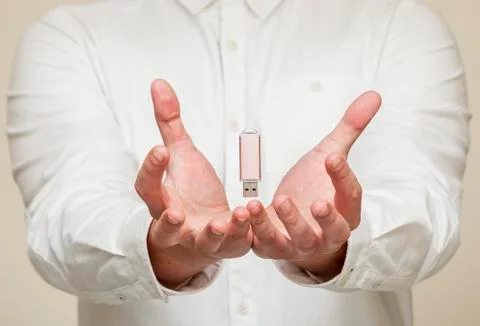 Memory card, usb levitation on the background of human hands Stock Photos