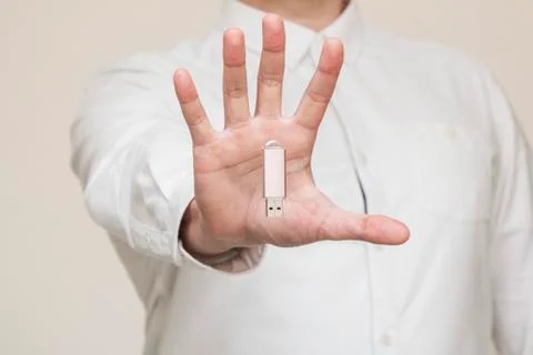 Memory card, usb levitation on the background of human hands Stock Photos