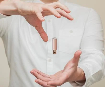 Memory card, usb levitation on the background of human hands Stock Photos