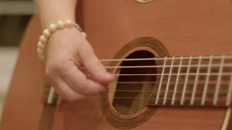 Memory Enhancement: Playing music involves memorization of chords, songs. Guitar Stock Footage 260089013