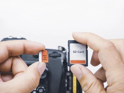 Memory micro SD and SD cards are compared for usage with digital DSLR camera Stock Photos