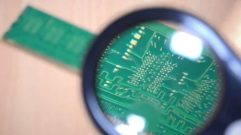 Memory module examination with magnifying glass. computer parts expertise Stock Footage 74061724