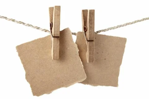 Memory sticky notes on craft rough paper hang on wooden clothespins on a braided Stock Photos