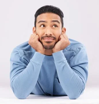Memory, thinking and young man in a studio resting on his arms with a problem Stock Photos