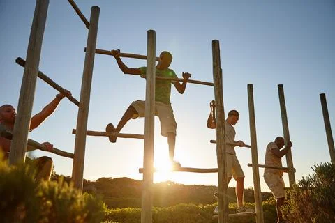 Men of action. a group of men going through an obstacle course at bootcamp. Photos