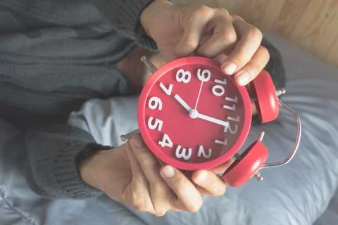 Men Alarm Clock with Bed Stock Photos