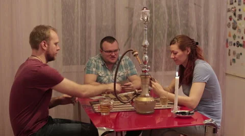 Men and woman smoking shisha and talking Stock Footage 59572313