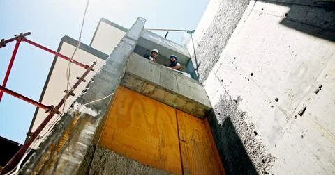 Men, architect and building with plan for industrial development, safety or Fotos de archivo