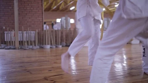 Men are engaged in karate. Execution of strikes with a sparing partner. Stock Footage 82669126