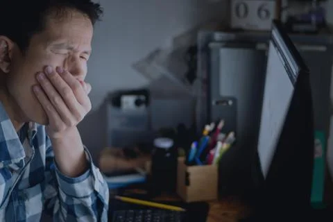 Men are gagging while yawning on the office desk in night time with overtime Stock Photos