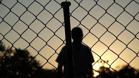 Men are hitting the baseball player with the sunset Stock Footage 121239016