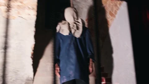 Men are imprisoned behind bars in cells and a man tries to commit suicide with a Stock Footage 159698330