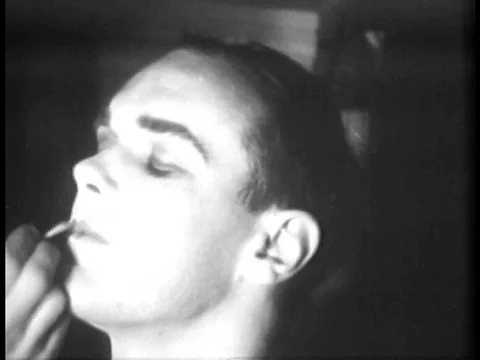 Men are made up and dressed to look like women, and dance on stage in 1934. Stock-Footage 74999109