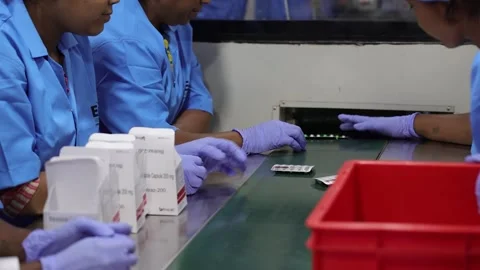 Men are packaging the capsules Stock Footage 277135519