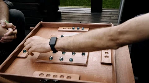 Men are playing a board game sitting on the terrace. Team building competitions Stock Footage 341677017