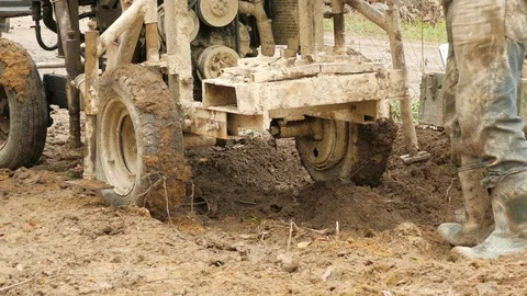 Men are pushing out of the mud a rusty improvised rig 스톡 동영상 105508258