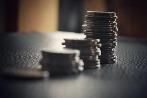 Men are saint documents about save money and put coin in glass jar on desk on Stock Photos