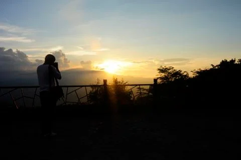 Men are shooting sunset. Stock Photos