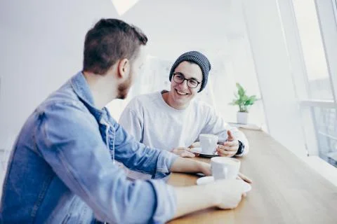 Men are sitting in front of the table near window Foto stock