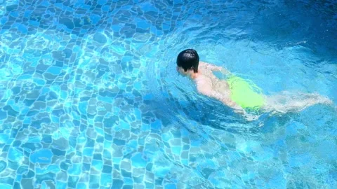 Men are swimming or diving in the pool. Young man exercising or relaxing in the  Stock Footage 182162887