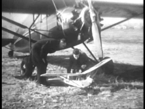 Men assemble and fly a model plane in 1934. Video stock 79463820