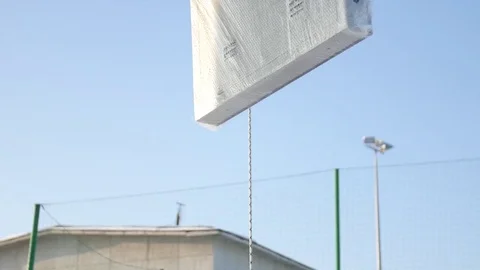Men assemble Billboard on tap. Builder on a Lift Platform at a construction site Vídeos de archivo 84954960