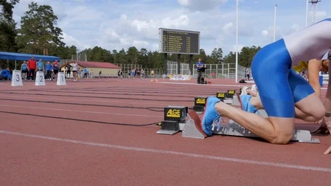 Men athletes sprinters starting block start and run Stock Footage 111216422