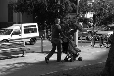 Men with baby stroller Stock Photos
