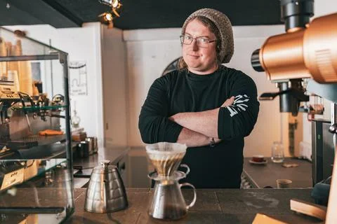 Men barista making a drip filter coffee standing by counter in coffeeshop and Stock Photos