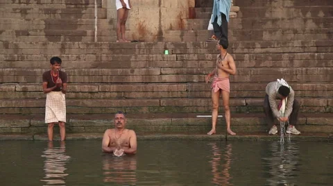 Men bathing and praying at Ganges river | Stock Video | Pond5