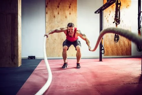 Men with battle rope in functional training fitness 写真素材