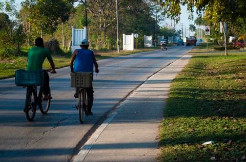 Men on bicycles returning from work on the streets of a city Stock Photos