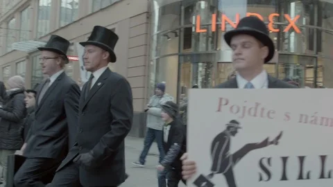 Men in black suits on International Silly Walk Day in Brno Stock Footage 101103553
