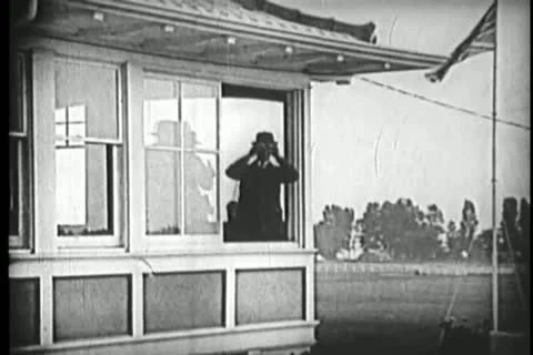Men in booth looking through binoculars Stock Footage 11351936
